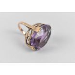 A Yellow Metal Mounted Amethyst Ring, the Large Faceted Cut Stone (Approx. 25ct) Mounted in Stylised