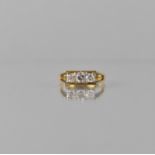 An 18ct Gold and Diamond Trilogy Ring, Centre Round Brilliant Cut Diamond Approx 0.37ct on Visual