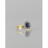 An 18ct Gold and Platinum Mounted Sapphire and Diamond Ring, Centre Elongated Cushion Cut Sapphire