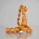 A String of Orange Bakelite Beads, Graduated Truncated Conical Form, Knotted Orange Thread with