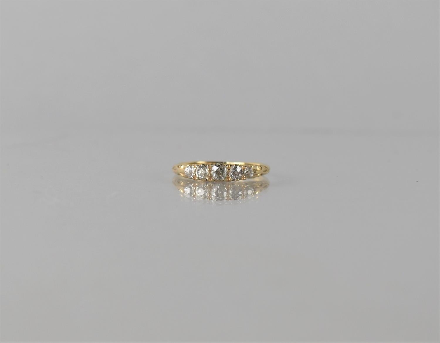 An Edwardian Five Stone Diamond Ring, The Central Old Cut Diamond Measuring 3.8mm W x 2.43mm D, with