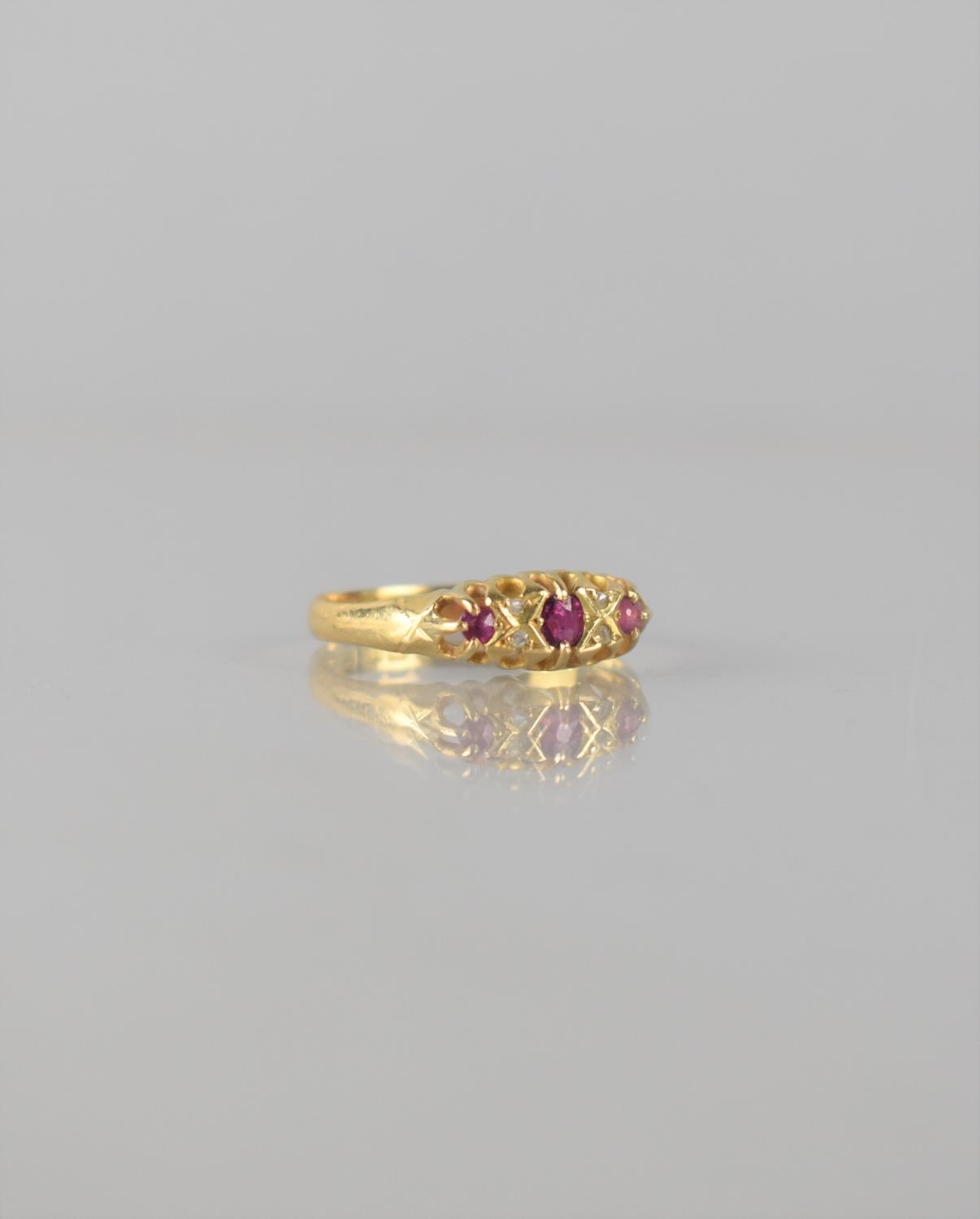 An 18ct Gold, Ruby and Diamond Seven Stone Boat Ring, Central Mixed Cut Ruby Measuring 3.5mm by