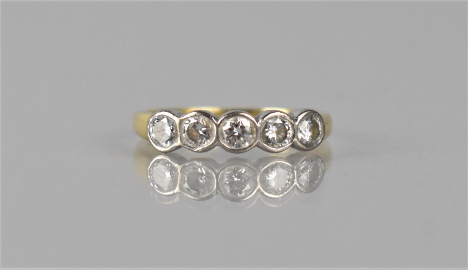 An 18ct Gold and Diamond Five Stone Dress Ring having Five Round/Oval Brilliant Cut Stones,