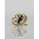 A Victorian Brooch, Three Cut Almandine Garnets, Largest 9.5mm by 8mm, Set in an Etched and Scrolled