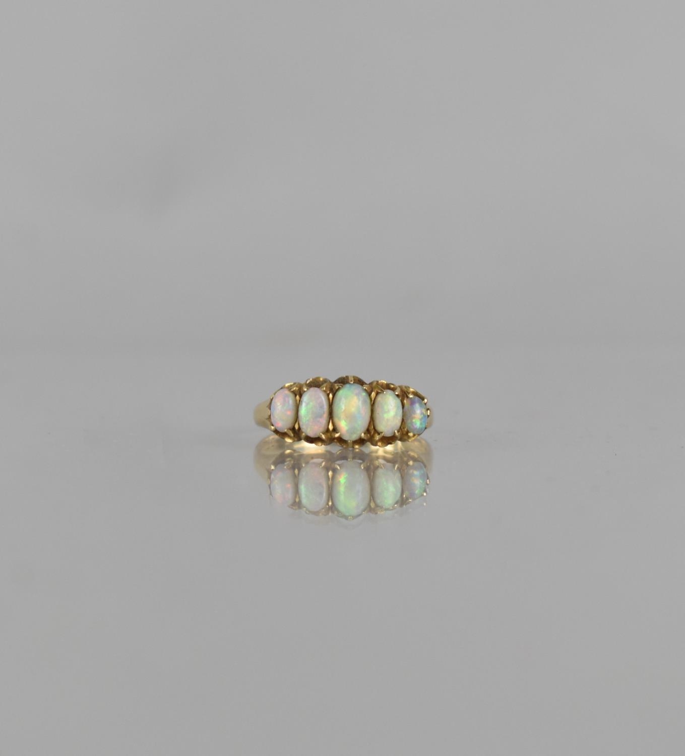 An Antique 18ct Gold and Five Stone Opal Ring, Centre Oval Cut Stone Measuring 5mm by 3mm, in Six