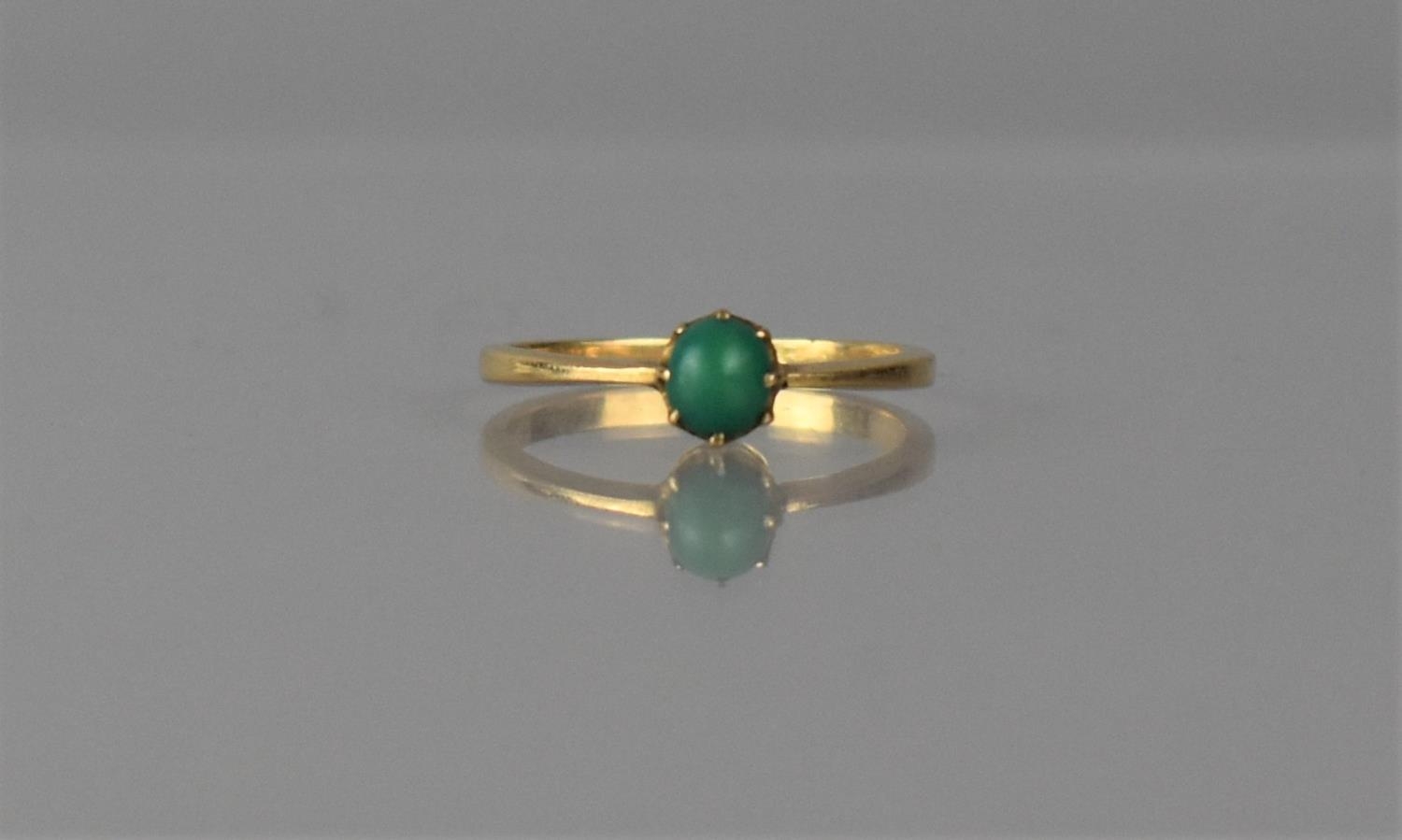 An Early 20th Century Cabochon Turquoise and Unmarked Gold Coloured Metal Dress Ring. Turquoise