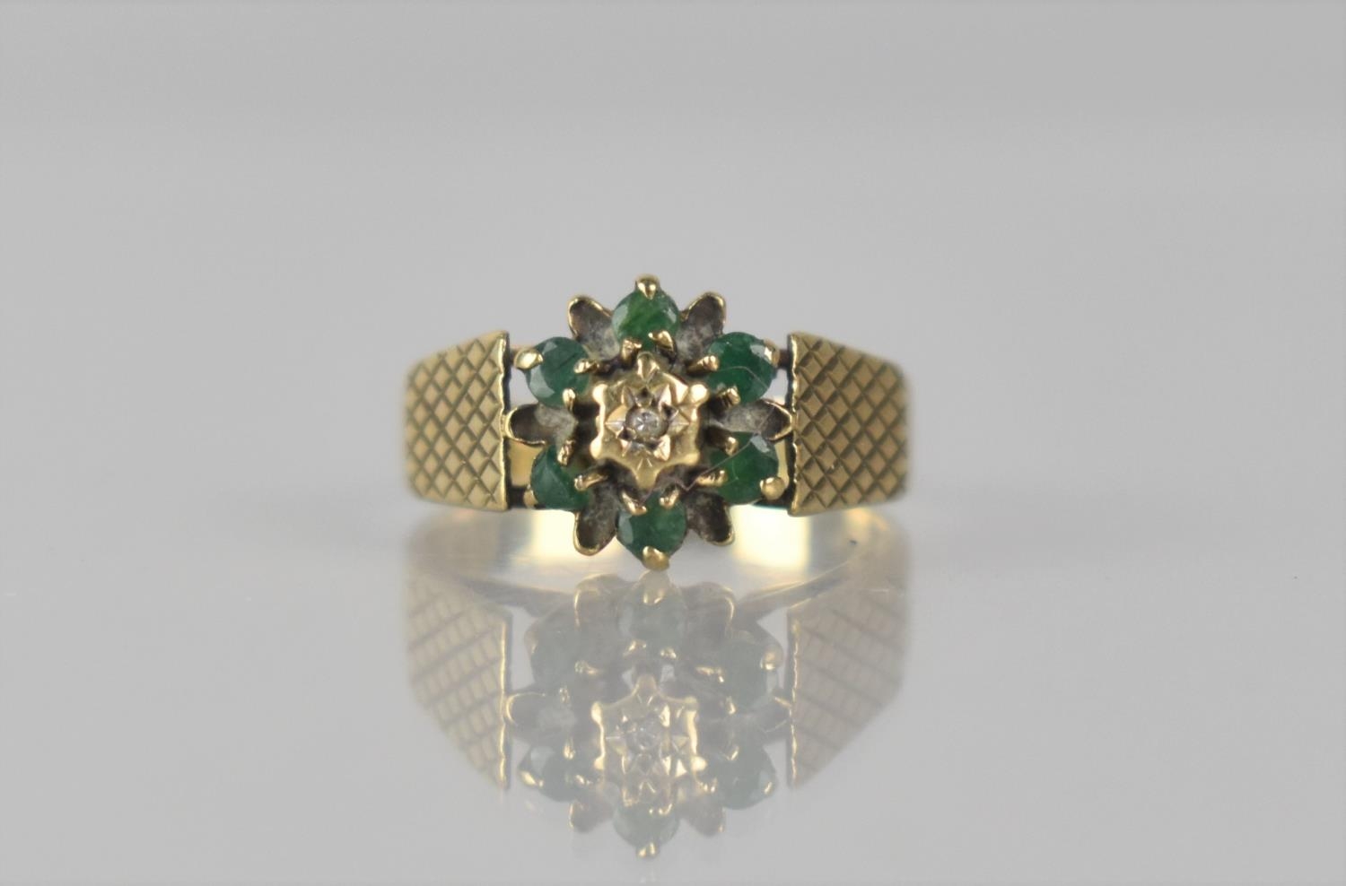 A 9ct Gold, Emerald and Diamond Cluster Ladies Dress Ring, Central Raised Small Round Cut Diamond,