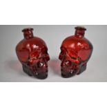 Two Ruby Glass Novelty Decanters in the Form of Skulls, 17cm high