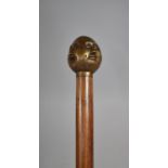 A Modern Turned Wooden Walking Cane with Bronze Four Sided Buddha Handle