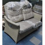 A Hartland Patio Rattan Two Seater Sofa, Cushions Still in Plastic Cover However Rattan Frame with