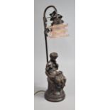 A Modern Bronze Effect Figural Table Lamp in the Form of Seated Maiden Reading Book, Opaque Pink