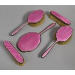 A Pink Enamelled and Silver Five Piece Dressing Table Set