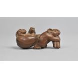 A Carved Wooden Netsuke in the Form of a Mouse Pulling Sack with Two Young Riding, Signed to Base,