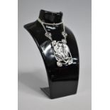 A Large Sterling Silver Pendant on Chain in the form of Maidens Head Surrounded by Flowers and