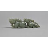 A Jade Effect of Two Temple Dogs Seated One Behind the Other, 10cm Long
