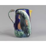 A 19th/20th Century Majolica Jug Decorated in Relief with Fish and with Stylised Fish Handle, Has