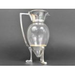 A Silver Plated and Glass Lidded Claret Jug in the Style of Christopher Dresser, 26cms High