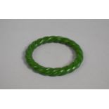 A Jade Effect Bangle of Twisted Form, 8cm diameter