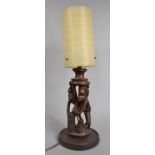 A Carved African Souvenir Figural Table Lamp with Shade, 54cms High