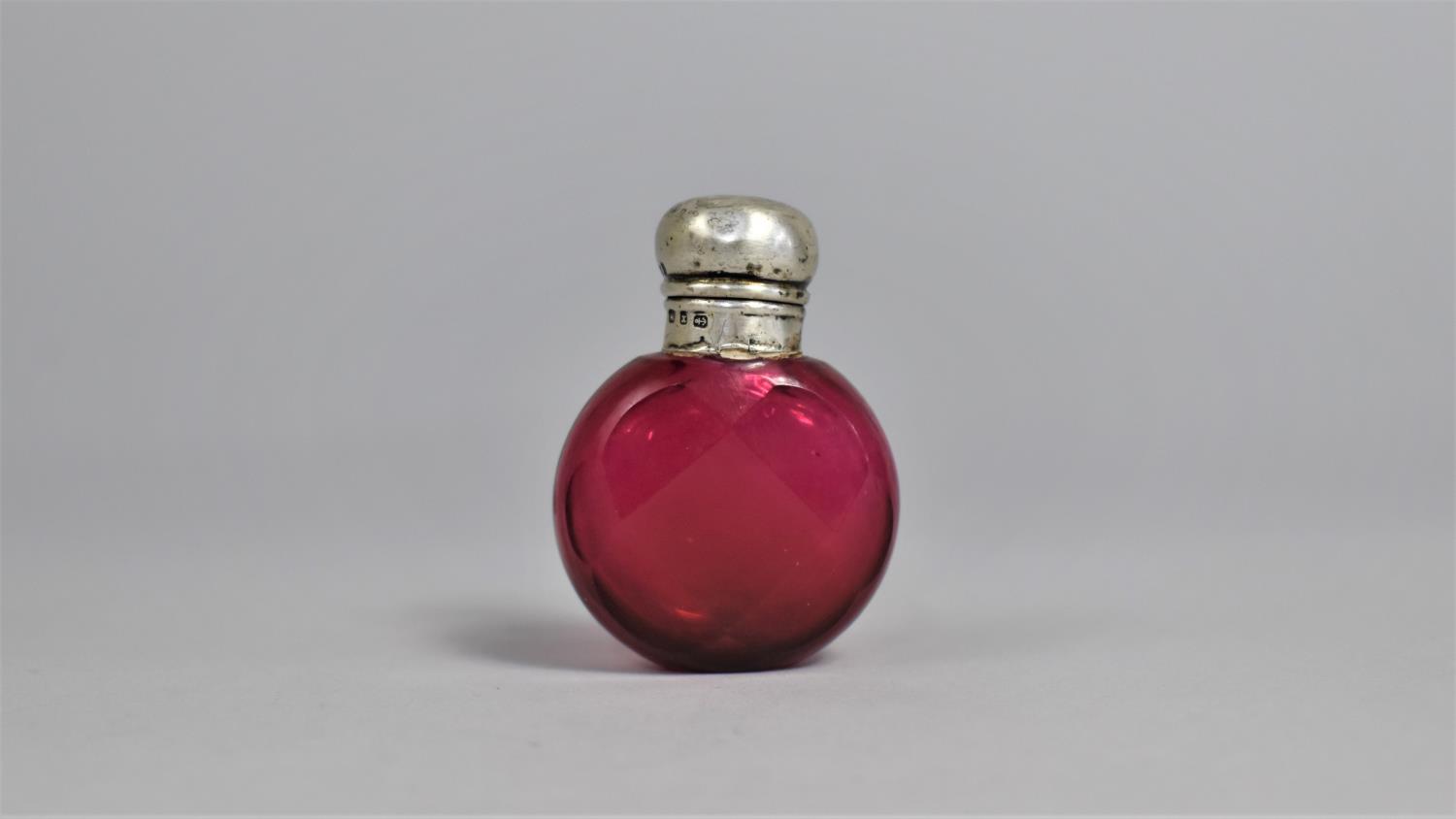 A Silver Top Ruby Faceted Scent Bottle, Birmingham Hallmark 1898 by H.C.F. Complete with Stopper,