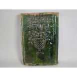 A 19th Century Green Glazed Terracotta Corner Tile Decorated in Relief with Urn of Flowers, 31cms by