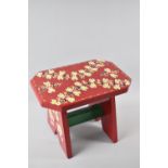 A Painted Wooden Bargeware Stool with Floral Decoration, 29cms Wide