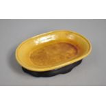 A Reproduction Glazed Dish with Incised Design on Wooden Stand, 11.5cm wide