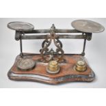 A Vintage Brass Postage Scale with Mixed Unrelated Weights on Serpentine Front Wooden Plinth Base,