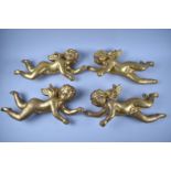 A Set of Two Pairs of Gilded Composition Wall Hangings in the form of Winged Cherubs, Each 38cms