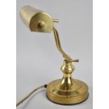 A Reproduction Brass Adjustable Desk Top Reading Light on Circular Plinth, 33cms High