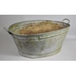 A Vintage Galvanised Bath with Twin Handles, 57cms Wide Max by 55cms by 30cms High