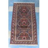 A Vintage Bokhara Type Pattern Rug on Burgundy Ground, 194x104cm