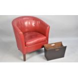 A Red Leather Effect Tub Armchair Together with a Magazine Store