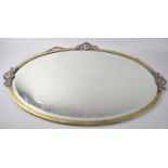 An Oval Brass Framed Mirror with Rose Decoration, 82x55cm