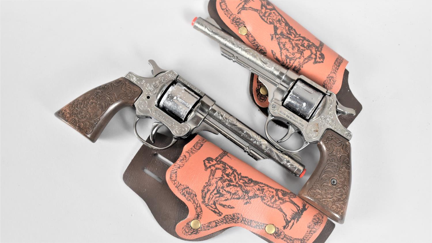Two Mid 20th Century Toy Revolvers with Holsters
