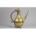 A 19th Century Islamic Brass Ewer with Hinged lid on Four Feet, Scrolled Handle, 25cms High