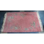 A Patterned Chinese Woollen Rug on Pink Ground, 189x125cm