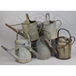 A Collection of Five Various Vintage Galvanized Watering Cans