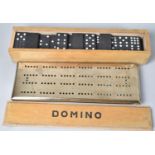 A Vintage Cast Bronze Cribbage Board together with a Mid 20th Century Set of Nine Spot Dominoes
