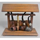 A Mid 20th Century Novelty Four Section Pipe Rack Containing Four Vintage Pipes, 23cms Wide