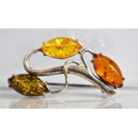 A Silver and Tri 'Amber' Brooch of Scrolled Branch Form, 4cm wide