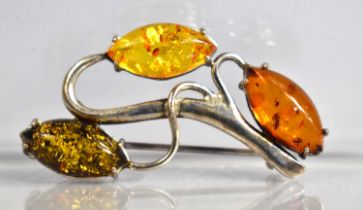 A Silver and Tri 'Amber' Brooch of Scrolled Branch Form, 4cm wide