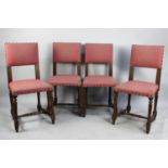 A Set of Four Upholstered Oak Framed Dining Chairs with Brass Studding