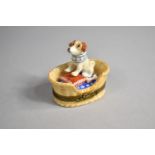 A Limoges Porcelain Box in the Form of a Dog's Basket with Terrier, Pillow and Bone