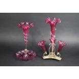 Two Late Victorian/Edwardian Cranberry Glass Epergnes, a Single Trumpet Example on Wavy Rim Dish and