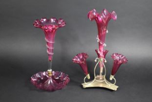 Two Late Victorian/Edwardian Cranberry Glass Epergnes, a Single Trumpet Example on Wavy Rim Dish and