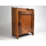 An Edwardian Oak Freestanding and Wall Hanging Small Cabinet with Panelled Door, 25cm wide and