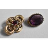 A Victorian Yellow Metal Brooch of Scrolled Form Having Chased decoration with Central Amethyst