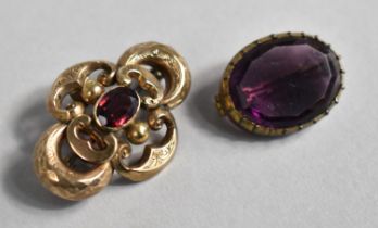 A Victorian Yellow Metal Brooch of Scrolled Form Having Chased decoration with Central Amethyst