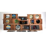 A Collection of Wooden Cased Coloured Magic Lantern Slides, Some with Moving Parts and Most